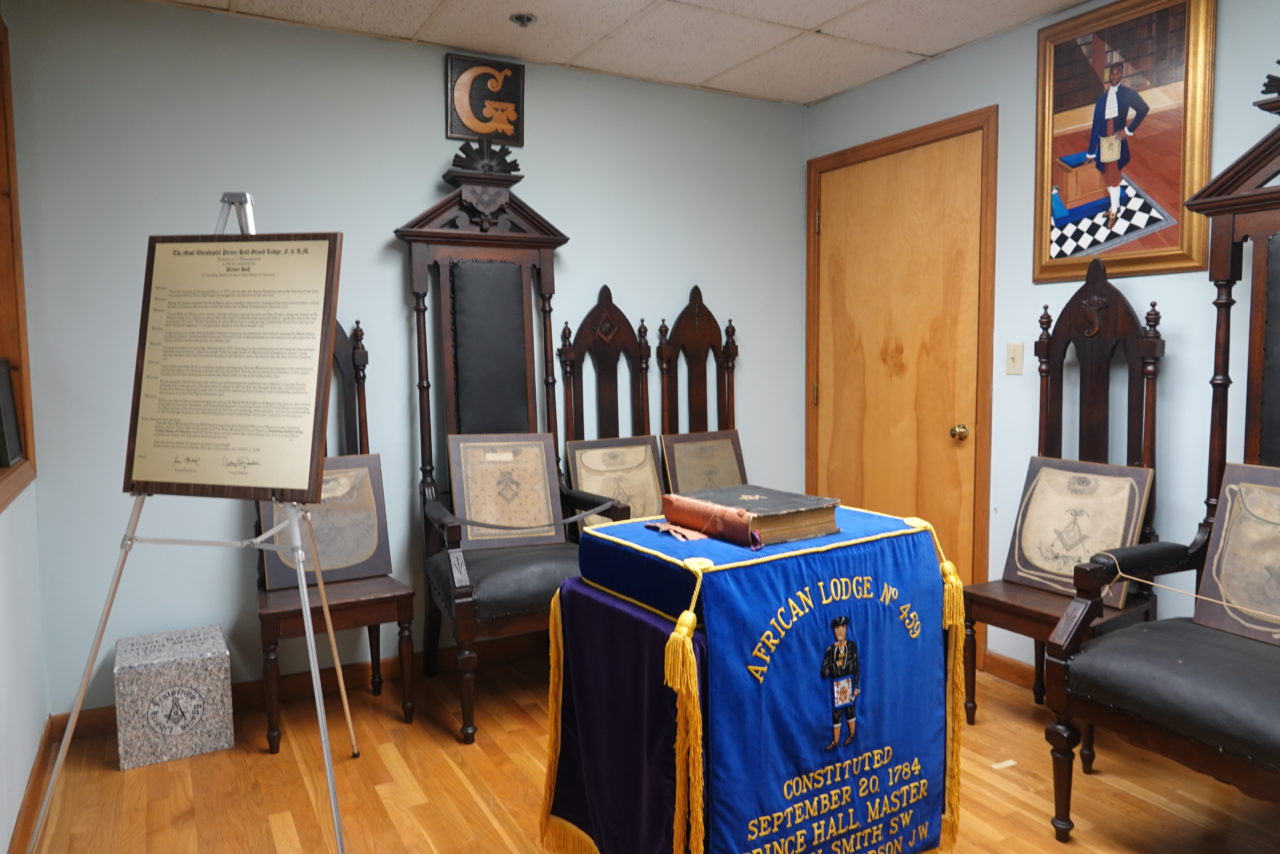 African Lodge altar draped in blue and gold, surrounded by artifacts